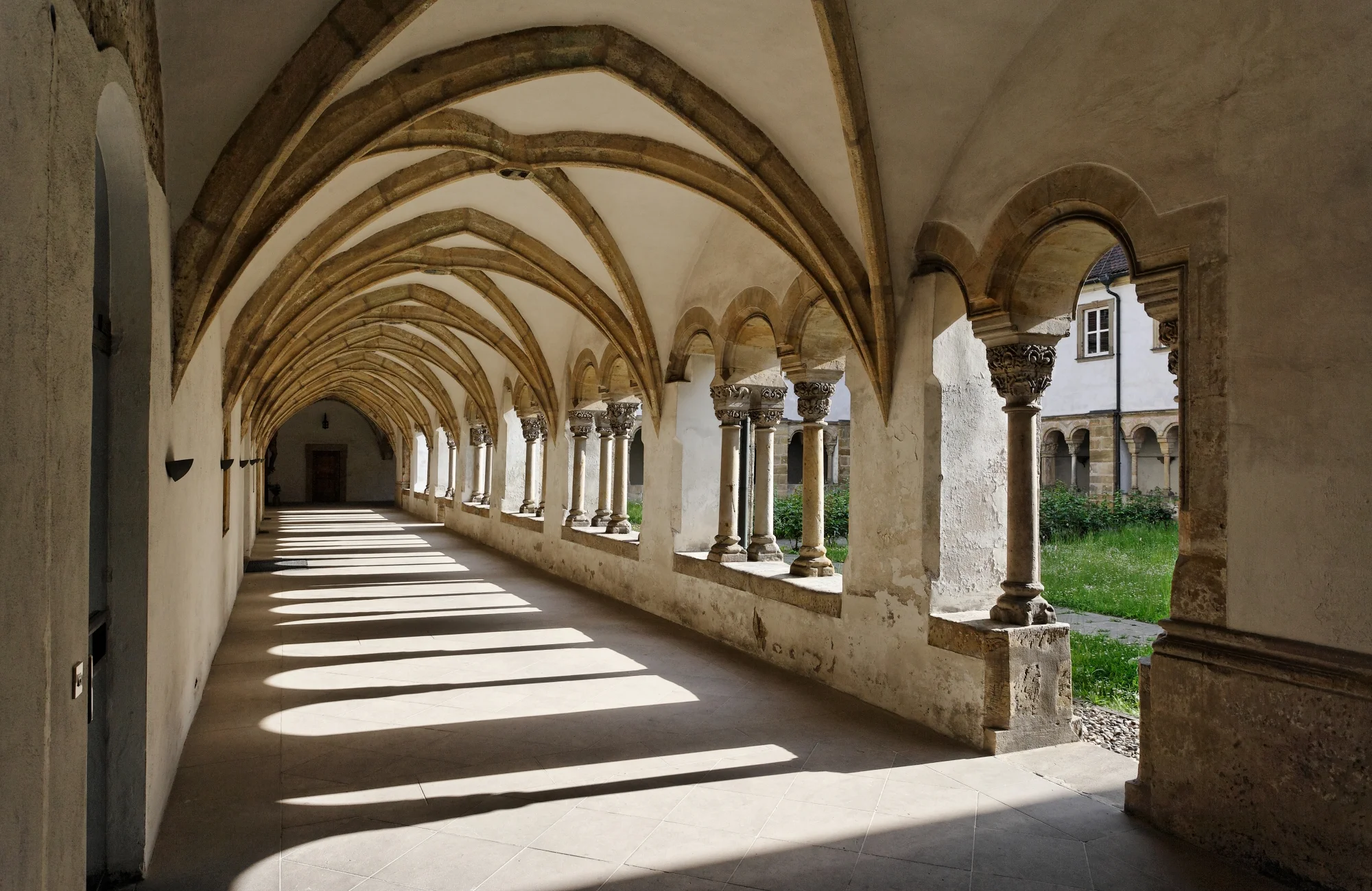 The monastery complex was built in the 12th century and redesigned in a baroque style in 1692-1701 by Leonhard Dientzenhofer. A late romantic cloister from the 13th century awaits the visitors behind the baroque doorway.