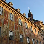 A bridge crossed the river already in the early 11 th century. Built in the middle of the 14th century, the town hall was rebuilt after a disasterous fire in 1440 by Bamberg's citizens. Michael Küchel redesigned it in rococo and baroque style between 1744-1756.  Beside the beautiful architecture, in particular the fescos captivate by their plasticity.