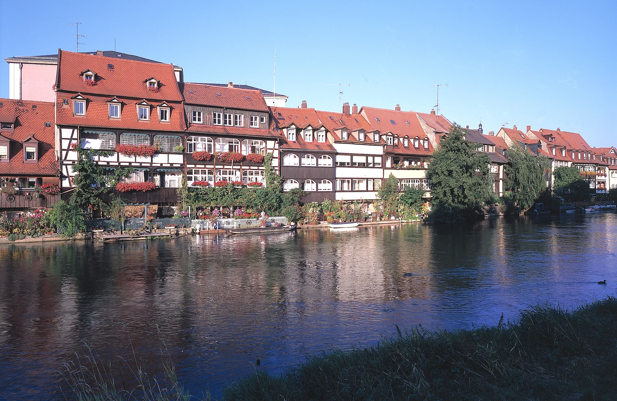 Klein Venedig "Klein Venedig" is the former settlement of fishermen along the River Regnitz. The pretty houses, which are lined up next to each other, are charming, especially when they are decorated and illuminated during the 'Sandkerwa' (Bamberg's famous annual fair). Some of the houses were built in the medieval times.