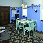 Equipment and furniture are exhibited in a typical house of a gardener, which delivers insight into the former lifeworld and working world.